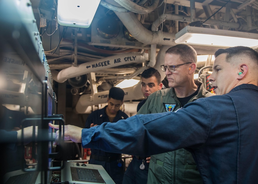 U.S. Navy Rear Adm. Michael Wettlaufer, commander of Carrier Strike Group (CSG) 3, visits with the crew of the guided-missile cruiser USS Mobile Bay