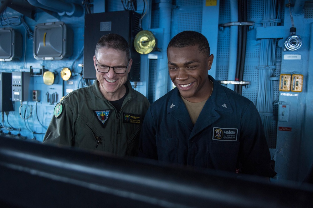 U.S. Navy Rear Adm. Michael Wettlaufer, commander of Carrier Strike Group (CSG) 3, visits with the crew of the guided-missile cruiser USS Mobile Bay