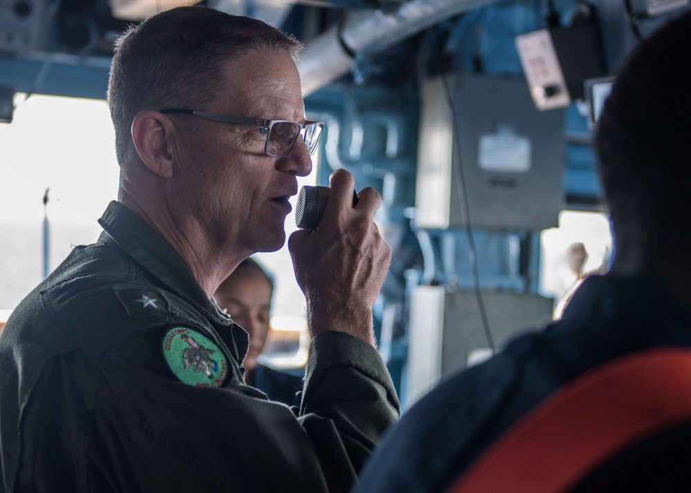 U.S. Navy Rear Adm. Michael Wettlaufer, commander of Carrier Strike Group (CSG) 3, visits with the crew of the guided-missile cruiser USS Mobile Bay