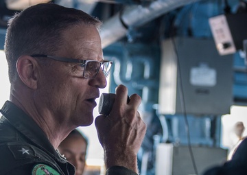 U.S. Navy Rear Adm. Michael Wettlaufer, commander of Carrier Strike Group (CSG) 3, visits with the crew of the guided-missile cruiser USS Mobile Bay
