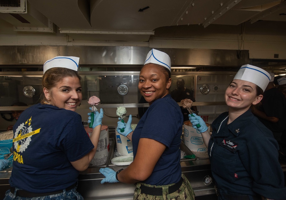 U.S. Sailors pose for a photo during an ice cream social event