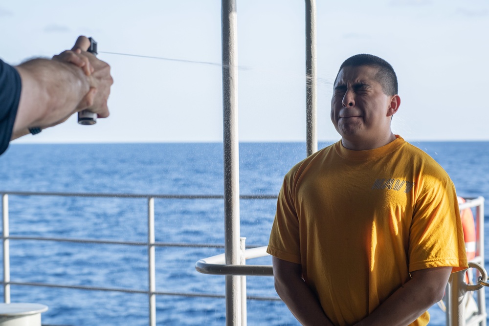 U.S. Sailors participate in an Oleoresin Capsicum (OC spray) training course