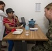 Lt. Sharon Hoff Observes Dr. Vanessa Monge Treating Patient during Pacific Partnership 2019