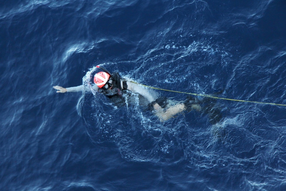 U.S. Navy Sailors recover a simulated man overboard during a man overboard drill aboard USS Spruance.