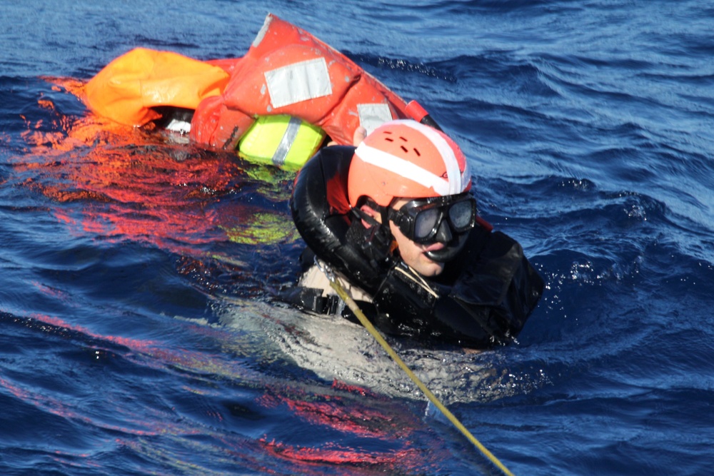 U.S. Navy Sailors recover a simulated man overboard during a man overboard drill aboard USS Spruance.