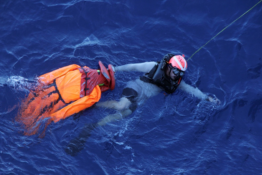 U.S. Navy Sailors recover a simulated man overboard during a man overboard drill aboard USS Spruance.