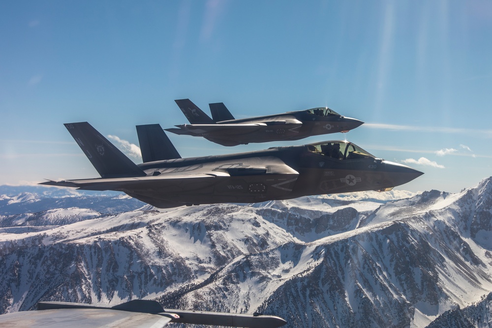 Two F-35C's Fly Over Snow Covered Sierra Mountains