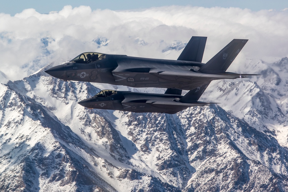 Two F-35C's Fly Over Snow Covered Sierra Mountains