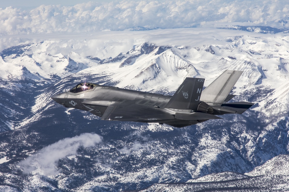 Two F-35C's Fly Over Snow Covered Sierra Mountains