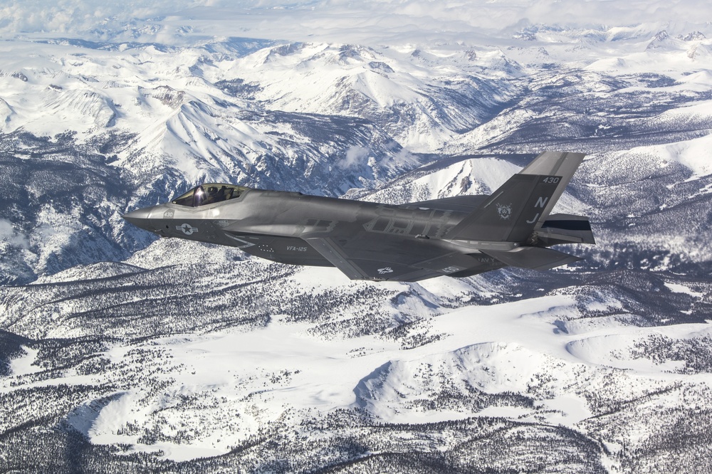 Two F-35C's Fly Over Snow Covered Sierra Mountains