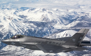 Two F-35C's Fly Over Snow Covered Sierra Mountains