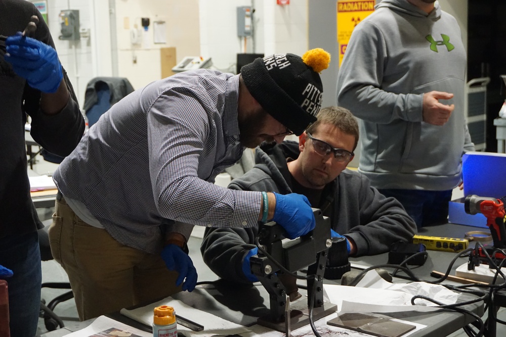 NDT technicians from Crane Army Ammunition Activity, Crane, Indiana, calibrate an eddy current test unit in preparation for testing during the hands-on portion of the NDT training conducted recently at Letterkenny Munitions Center.