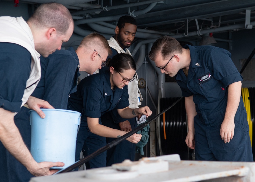 U.S. Sailors retrieve a cable for a Nixie torpedo countermeasure system