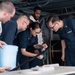 U.S. Sailors retrieve a cable for a Nixie torpedo countermeasure system