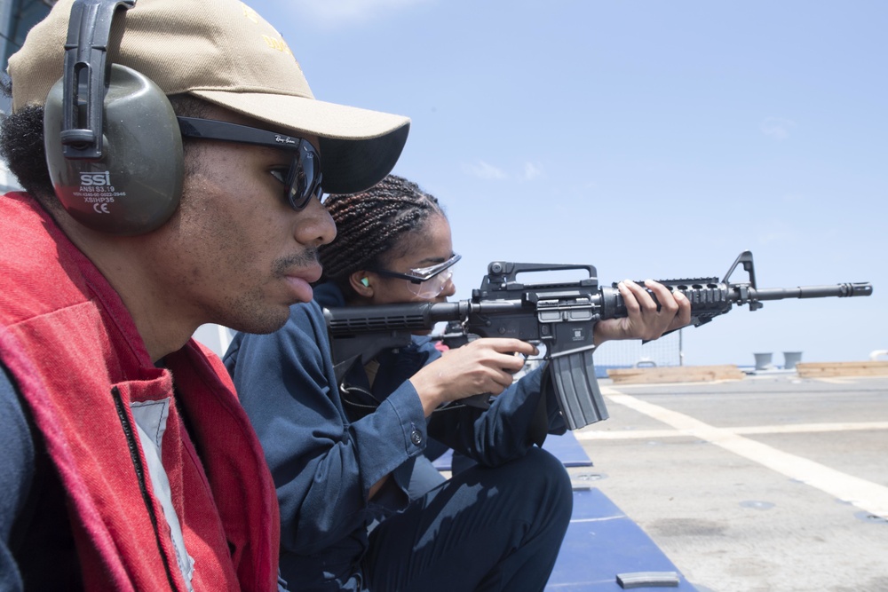 U.S. Navy Sailors participate in a small-arms weapons qualification gun shoot aboard USS Spruance (DDG 111)