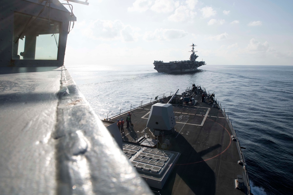 The USS Spruance conducts a replenishment-at-sea with the aircraft carrier USS John C. Stennis.