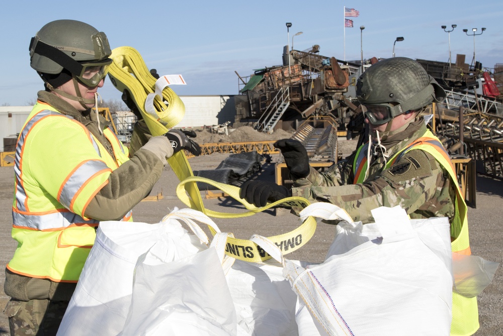 Soldiers conduct rigging and hookup operations to fight the flood waters