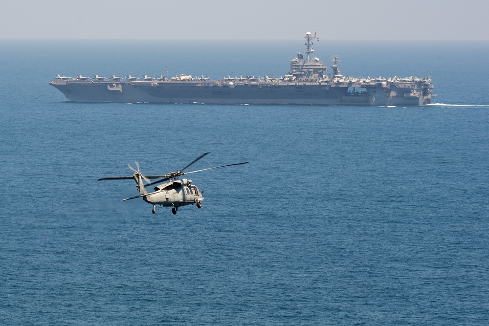 An MH-60S Sea Hawk, assigned to Helicopter Sea Combat Squadron (HSC) 14, flies toward the aircraft carrier USS John C. Stennis (CVN 74)