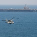 An MH-60S Sea Hawk, assigned to Helicopter Sea Combat Squadron (HSC) 14, flies toward the aircraft carrier USS John C. Stennis (CVN 74)