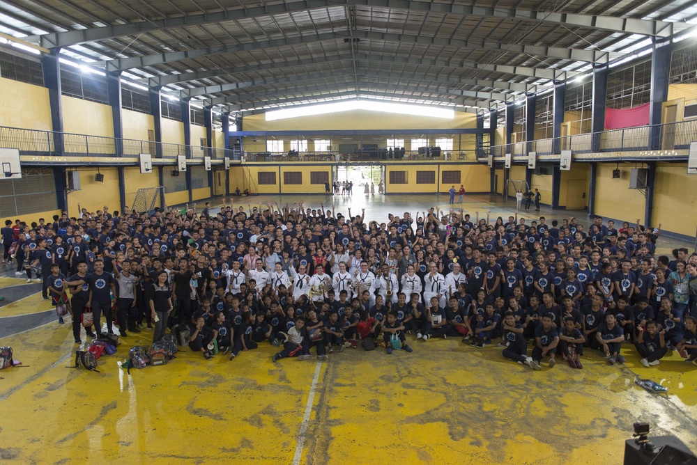 Members of the U.S. 7th Fleet Band pose for a photo with students from the Tuloy Foundation