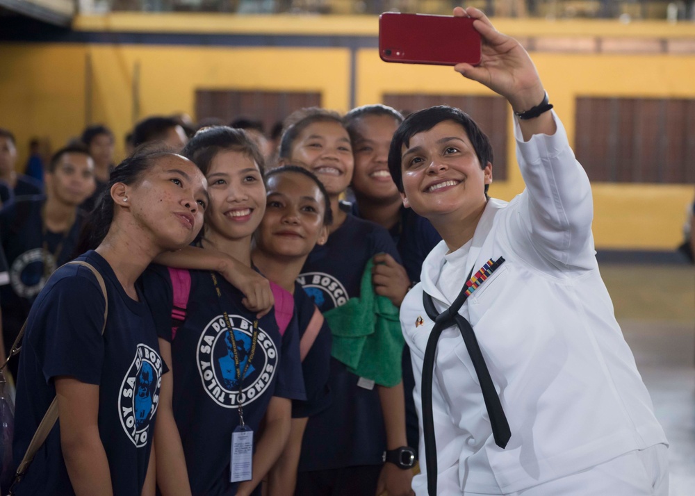 Musician 3rd Class T'anna Tercero, assigned to the U.S. 7th Fleet Band, captures a selfie with students at the Tuloy Foundation