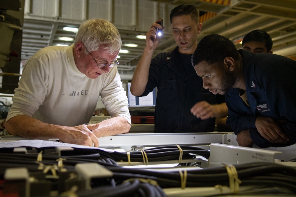 U.S. Sailors inspect wiring