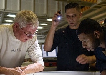 U.S. Sailors inspect wiring