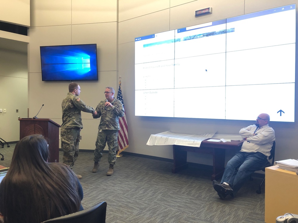 Nebraska National Guard Soldier receives coin from Adjutant General