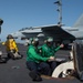 U.S. Sailors signal aircraft