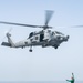 U.S. Sailor signals an MH-60R Sea Hawk assigned to Helicopter Maritime Strike Squadron (HSM) 71