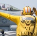 U.S. Sailor directs an F/A-18E Super Hornet assigned to Strike Fighter Squadron (VFA) 97