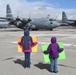 Children of Nevada Air Guardsmen patiently wait as a C-130 from the 152nd Airlift Wing parks after a five-month deployment to Middle East
