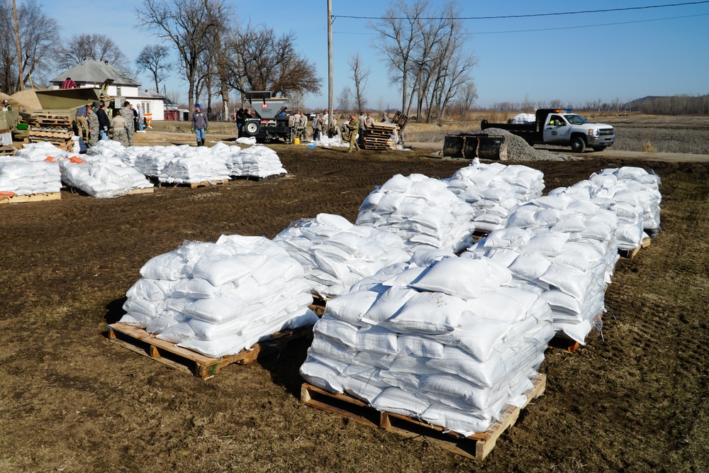Airmen fill sandbags for flood relief