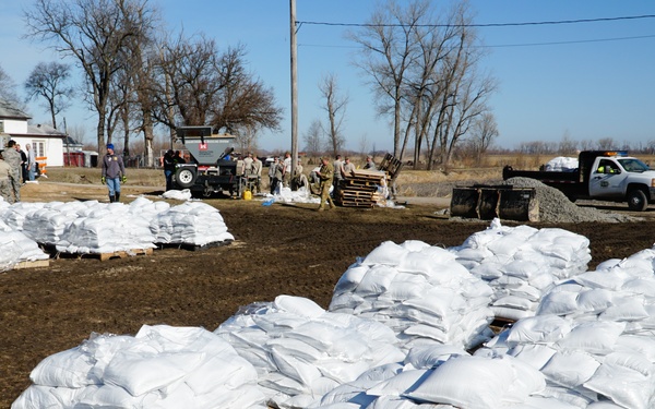 Airmen fill sandbags for flood relief