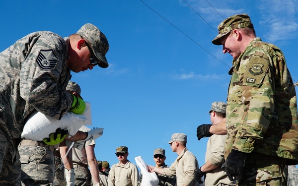 Airmen fill sandbags for flood relief