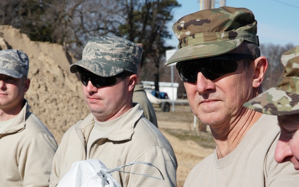 Airmen fill sandbags for flood relief