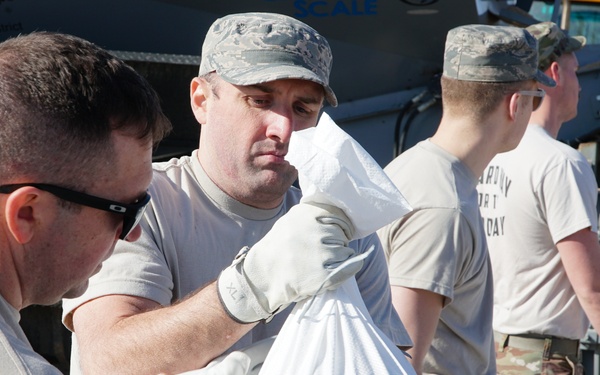 Airmen fill sandbags for flood relief