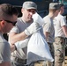 Airmen fill sandbags for flood relief