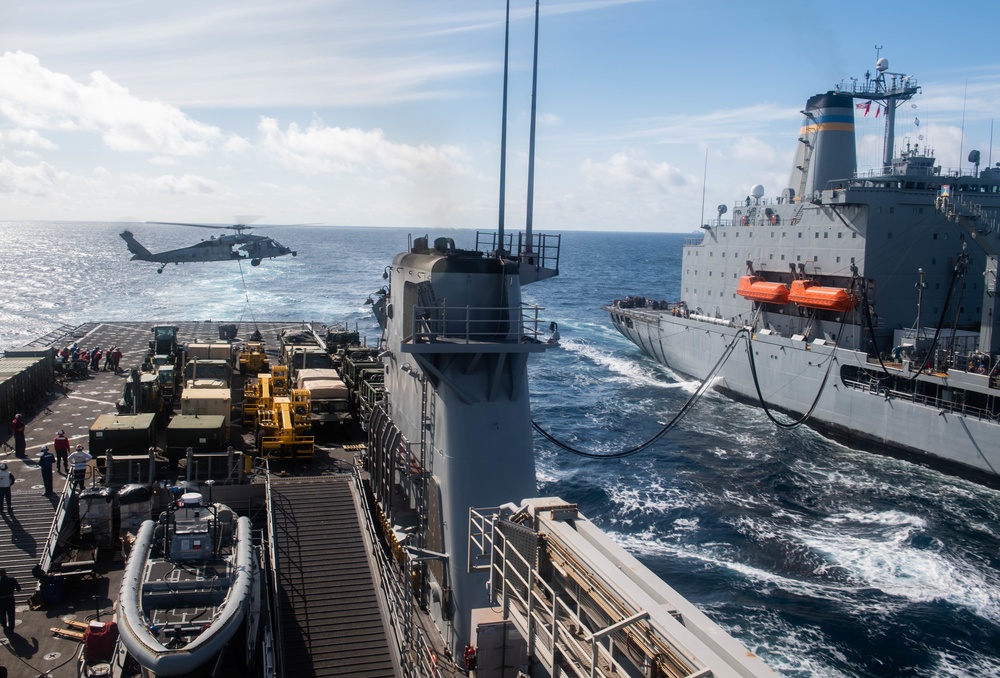 USS Harpers Ferry Conducts A Replenishment At Sea