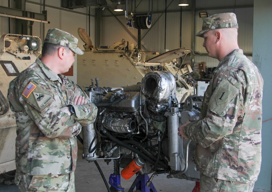 Soldiers perform services and maintenance on equipment