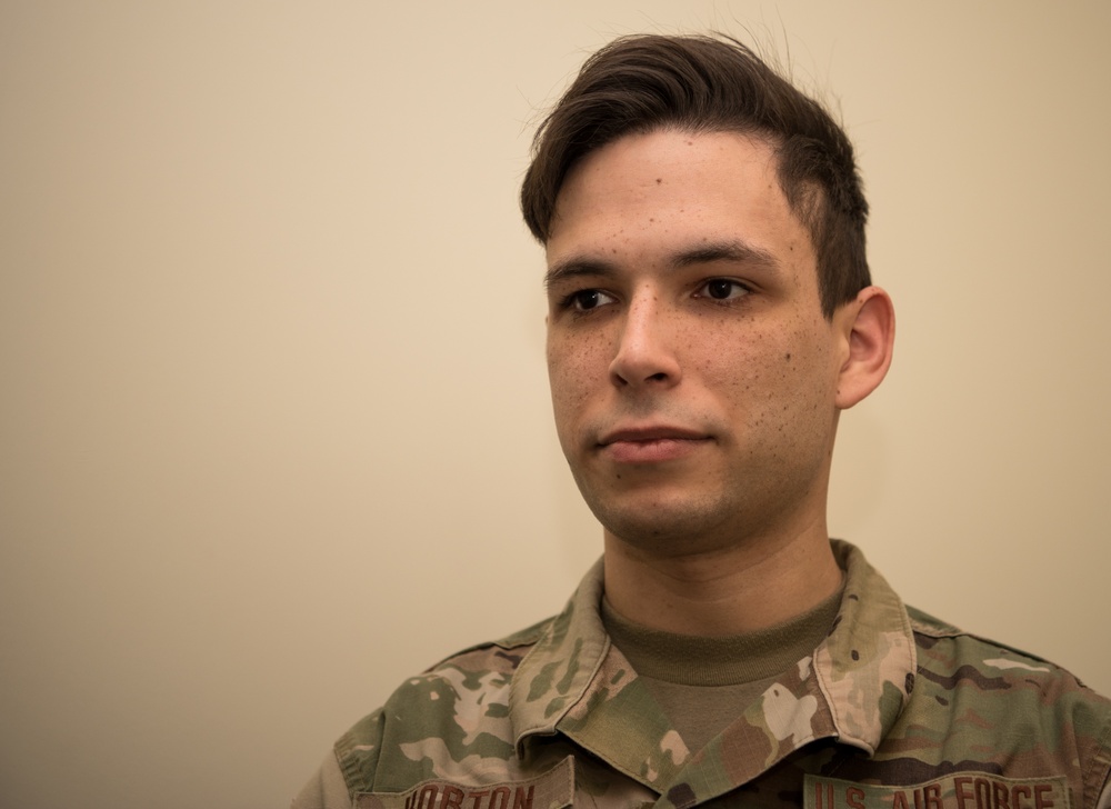 Photojournalist from 123rd Airlift Wing Poses to Demonstrate Bounce Flash Technique