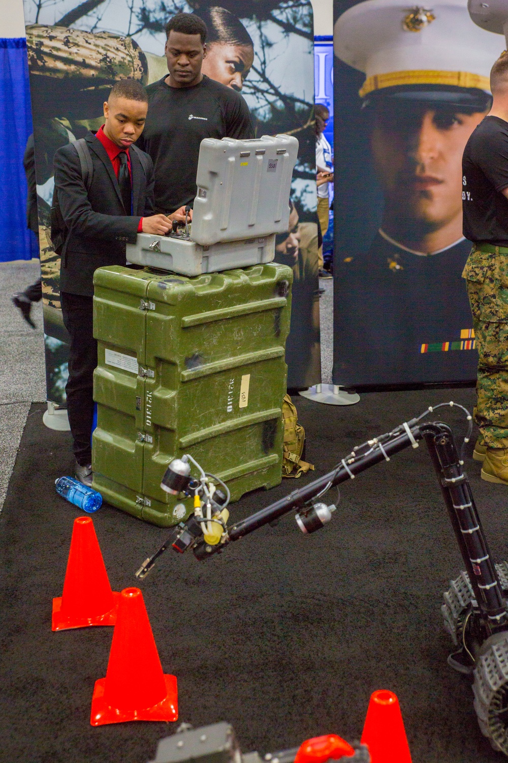 Marines showcase explosive ordnance disposal robots and flight simulator during National Society of Black Engineers conference