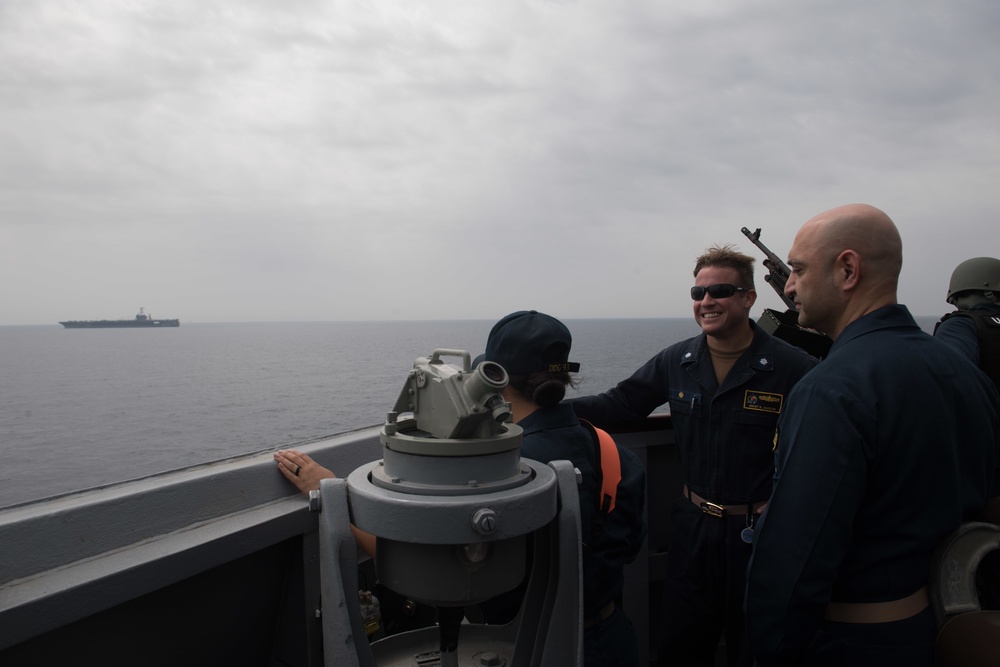 U.S. Navy Capt. Murz Morris, commodore, Destroyer Squadron (DESRON) 21, and U.S. Navy Cmdr. Brent Jackson, the commanding officer of the guided-missile destroyer USS Chung-Hoon, converse.