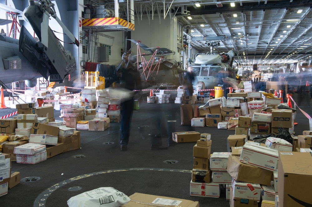 U.S. Sailors sort mail