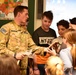 Sky Soldiers unwrap a MRE to show Slovenian children what we eat in the field
