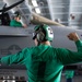 U.S. Sailor signals during a low-power turn