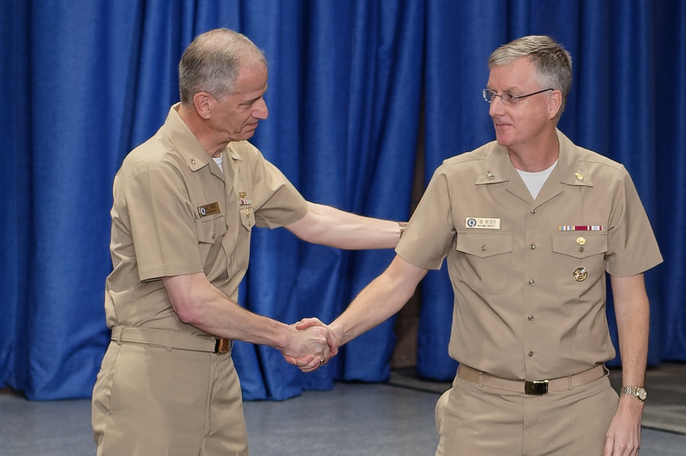 Rear Adm. Paul Pearigen congratulates Capt. Timothy Weber