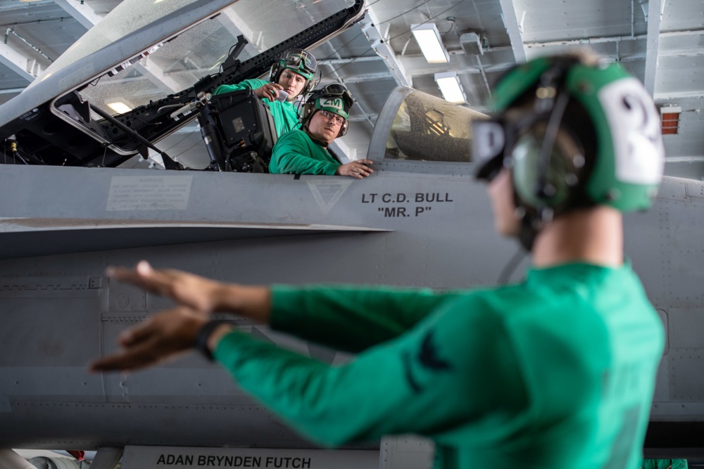 U.S. Sailor signals during a low-power turn