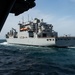 The dry cargo and ammunition ship USNS Charles Drew (T-AKE 10) steams alongside the aircraft carrier USS John C. Stennis (CVN 74)