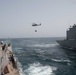 An MH-60R Sea Hawk transports cargo from USNS Kanawha